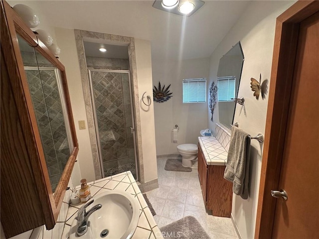 bathroom featuring vanity, toilet, an enclosed shower, and tile patterned flooring