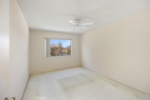 spare room featuring ceiling fan and a textured ceiling