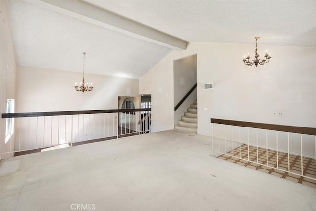 carpeted spare room featuring lofted ceiling with beams and an inviting chandelier