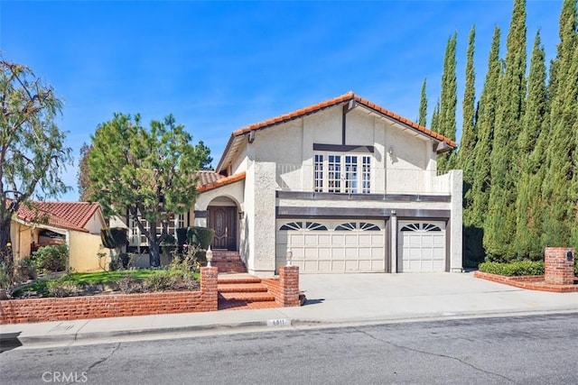 mediterranean / spanish house with a garage