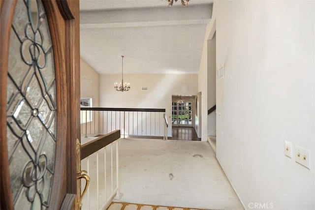 hallway featuring a chandelier and lofted ceiling with beams