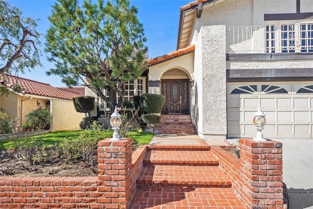 property entrance with a garage and a balcony