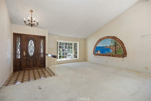 entryway with carpet, an inviting chandelier, a textured ceiling, and lofted ceiling