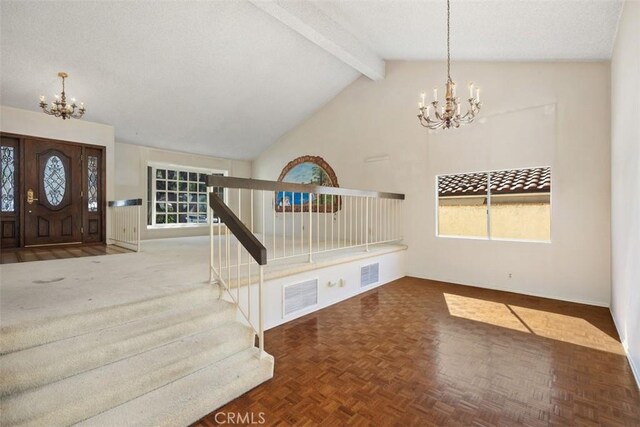 entrance foyer with beam ceiling, high vaulted ceiling, an inviting chandelier, and dark parquet floors