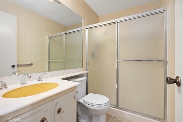 bathroom featuring an enclosed shower, tile patterned flooring, toilet, a textured ceiling, and vanity