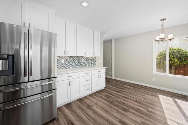 kitchen with hardwood / wood-style floors, white cabinetry, backsplash, stainless steel fridge with ice dispenser, and an inviting chandelier