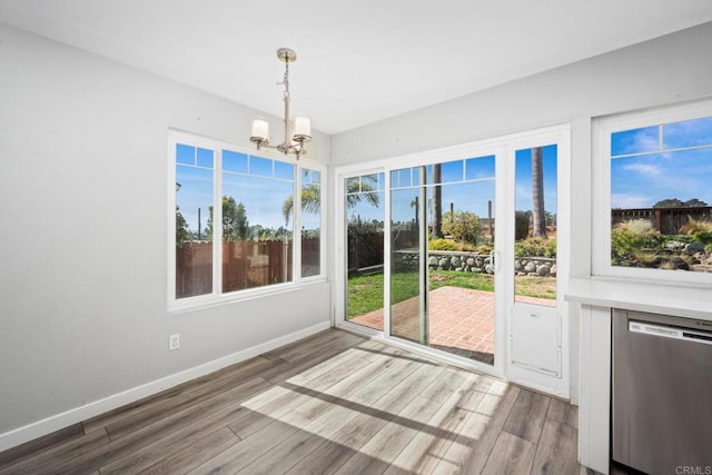 unfurnished sunroom featuring a notable chandelier