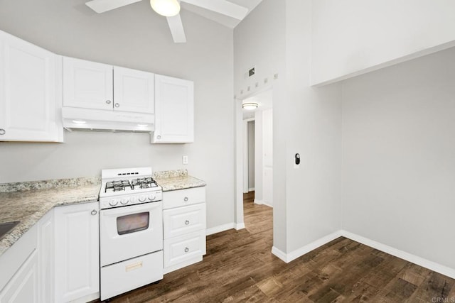 kitchen with white cabinetry, light stone countertops, dark hardwood / wood-style flooring, and white gas range oven