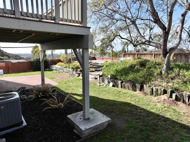 view of yard with central AC and a patio