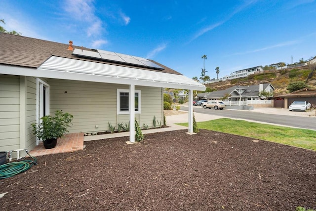 back of house featuring solar panels