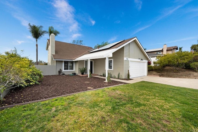 view of front facade with a garage, a front lawn, and solar panels