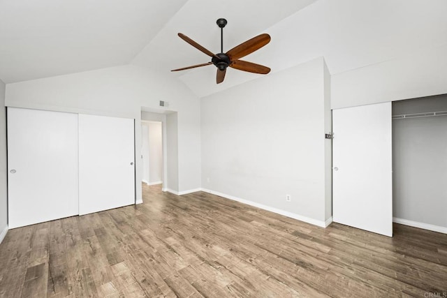 unfurnished bedroom featuring wood-type flooring, lofted ceiling, and ceiling fan