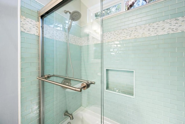 bathroom featuring shower / bath combination with glass door