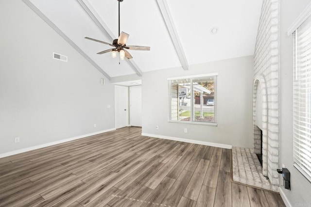 unfurnished living room with ceiling fan, high vaulted ceiling, beam ceiling, and hardwood / wood-style floors