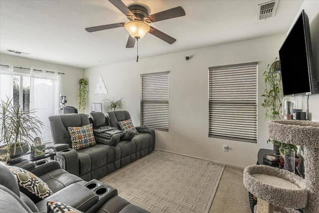 living room with light carpet and ceiling fan