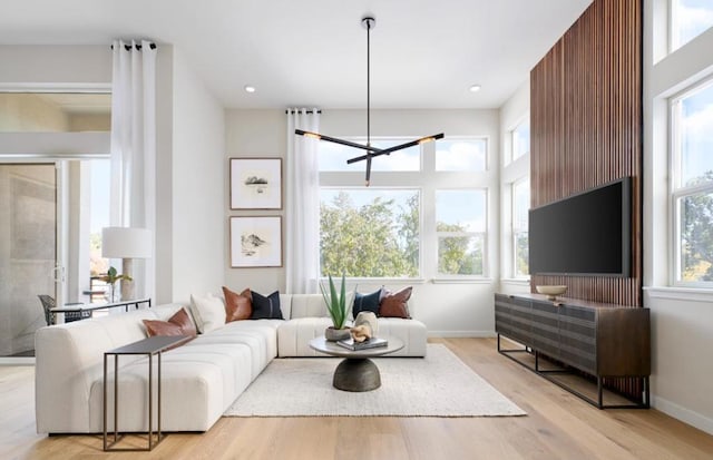 living room featuring a healthy amount of sunlight and light hardwood / wood-style floors