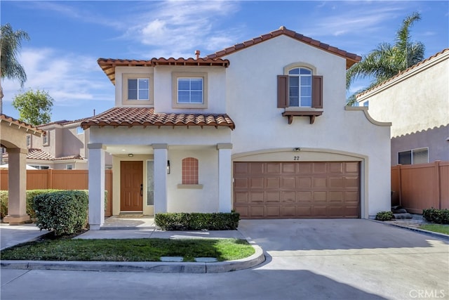 mediterranean / spanish-style home with a garage