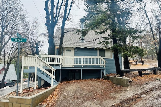 back of house featuring a deck