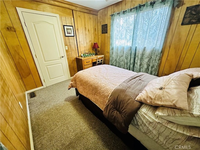 bedroom featuring carpet floors and wood walls