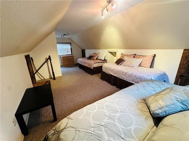 carpeted bedroom with rail lighting, vaulted ceiling, and a textured ceiling