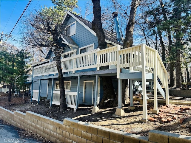 back of house featuring a wooden deck