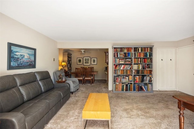 carpeted living room with ceiling fan