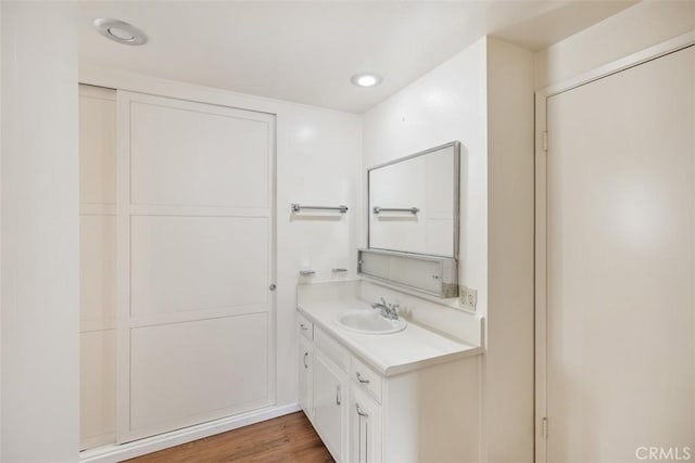 bathroom with vanity and hardwood / wood-style floors