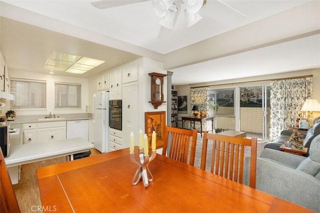 dining space with sink and ceiling fan