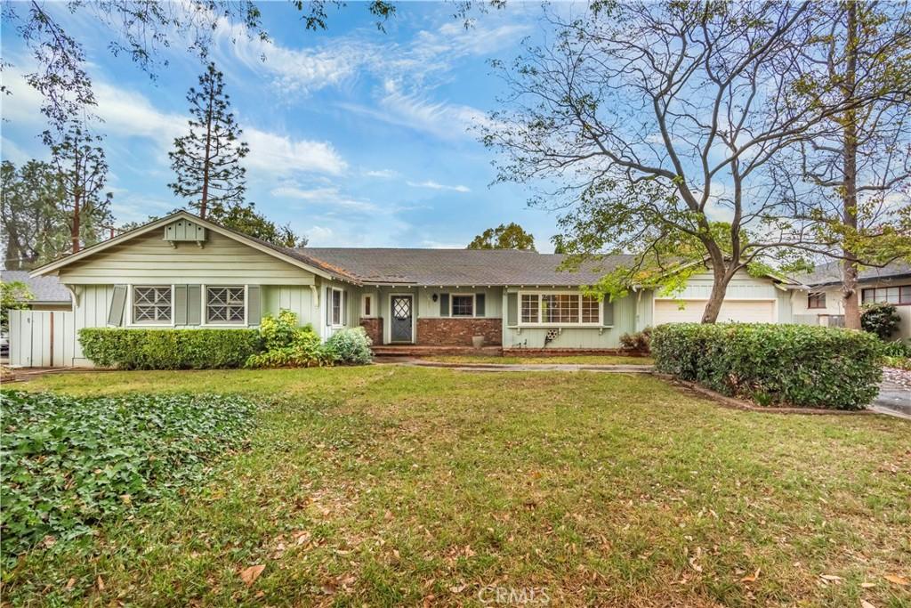 single story home with a garage and a front yard