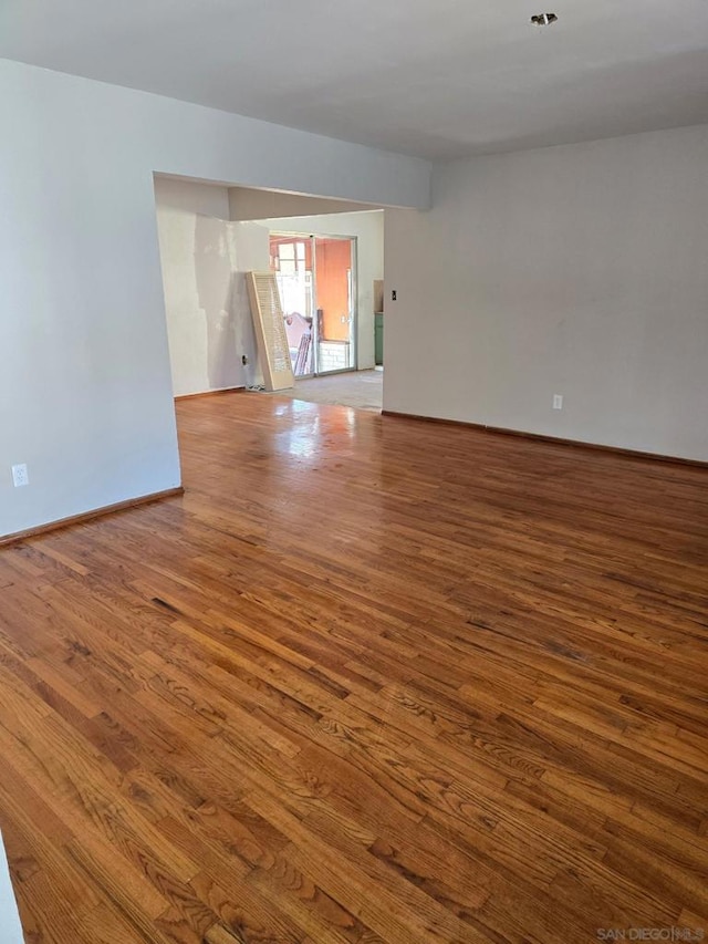 unfurnished room with hardwood / wood-style flooring