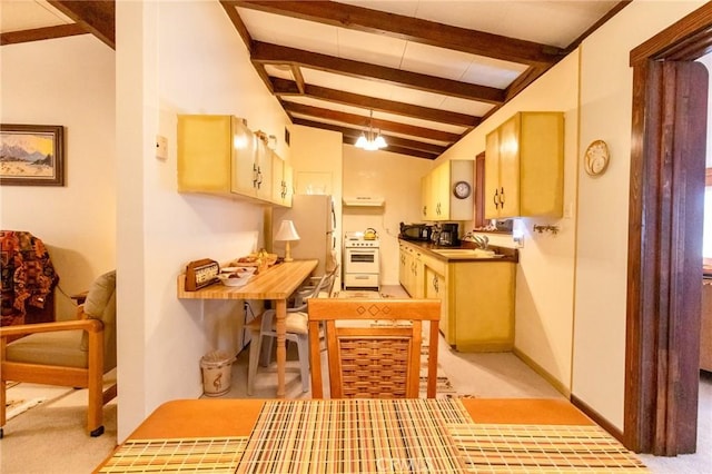 kitchen featuring sink, white stove, vaulted ceiling with beams, fridge, and light colored carpet