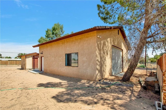 view of property exterior featuring an outdoor structure