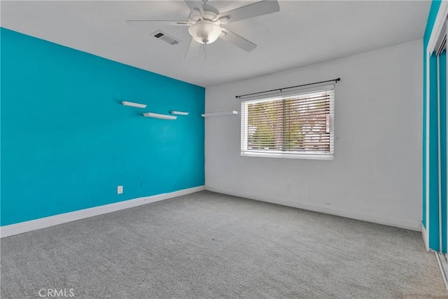 empty room featuring carpet floors and ceiling fan