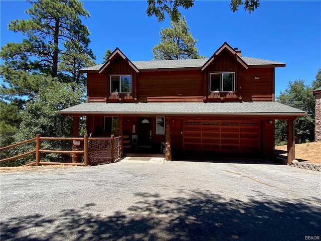 view of front of property featuring a garage and a porch