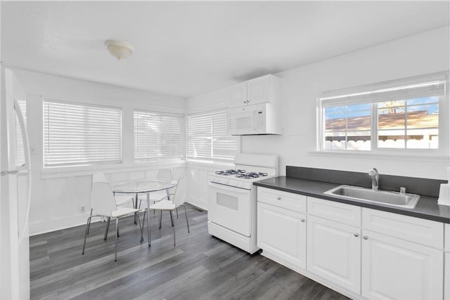 kitchen with sink, white appliances, dark wood-type flooring, and white cabinets