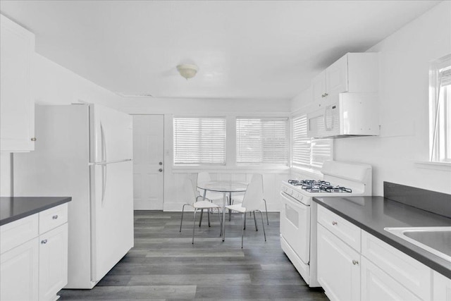 kitchen featuring white cabinetry, white appliances, and a healthy amount of sunlight