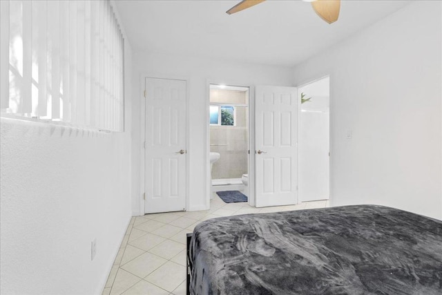 bedroom featuring light tile patterned floors and ensuite bath