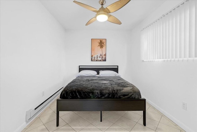 tiled bedroom with a baseboard heating unit and ceiling fan