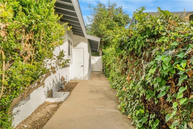 view of home's exterior with fence and stucco siding