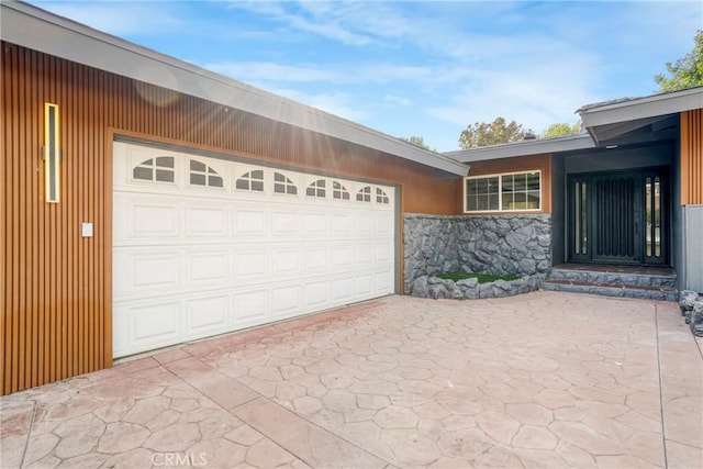 garage with concrete driveway