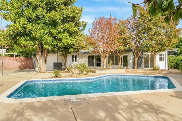 pool featuring a patio area and fence