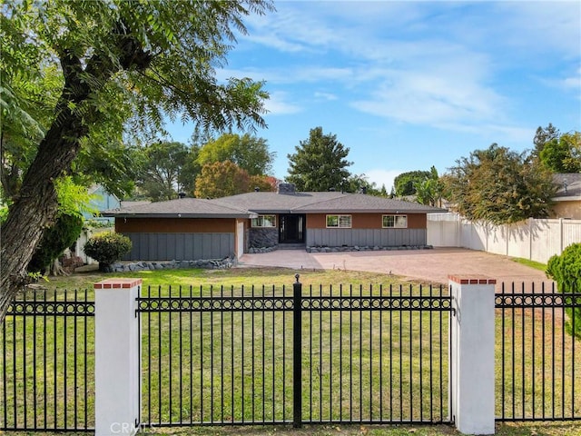 view of front of house with a fenced front yard, a front lawn, and board and batten siding