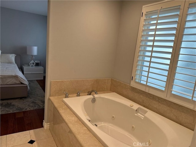 bathroom featuring tile patterned floors and tiled bath