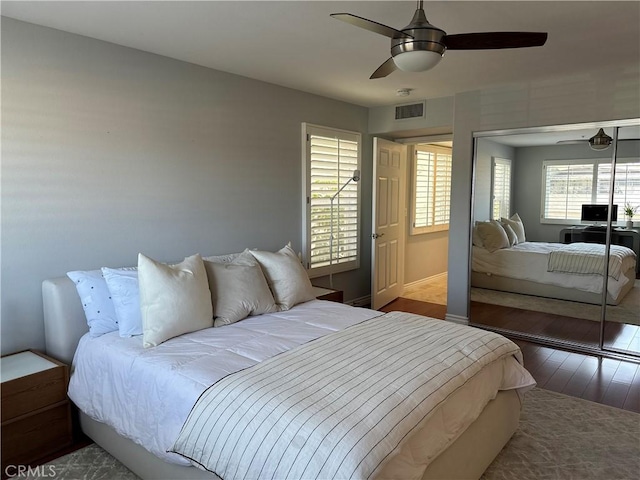 bedroom featuring ceiling fan, hardwood / wood-style floors, and a closet