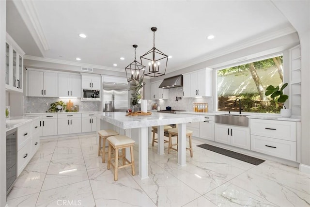 20 Bentley Rd, Coto De Caza, CA 92679 - kitchen with a sink, built in appliances, wine cooler, a chandelier, and decorative backsplash