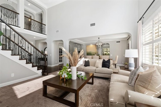 20 Bentley Rd, Coto De Caza, CA 92679 - living area with arched walkways, a towering ceiling, a chandelier, baseboards, and ornamental molding
