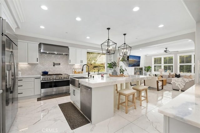 20 Bentley Rd, Coto De Caza, CA 92679 - kitchen with high end appliances, a sink, wall chimney exhaust hood, healthy amount of natural light, and recessed lighting