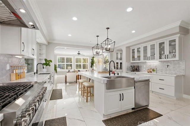 20 Bentley Rd, Coto De Caza, CA 92679 - kitchen featuring a sink, stainless steel dishwasher, arched walkways, recessed lighting, and crown molding