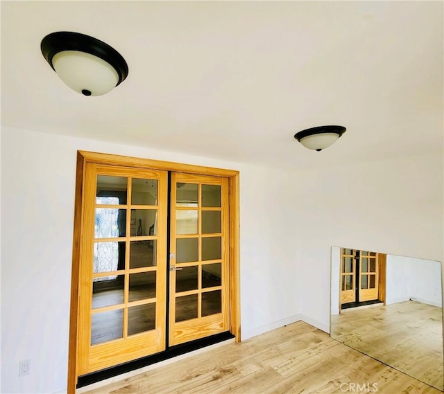 interior space featuring light wood-type flooring and french doors