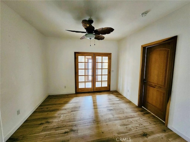 empty room with light hardwood / wood-style flooring, french doors, and ceiling fan